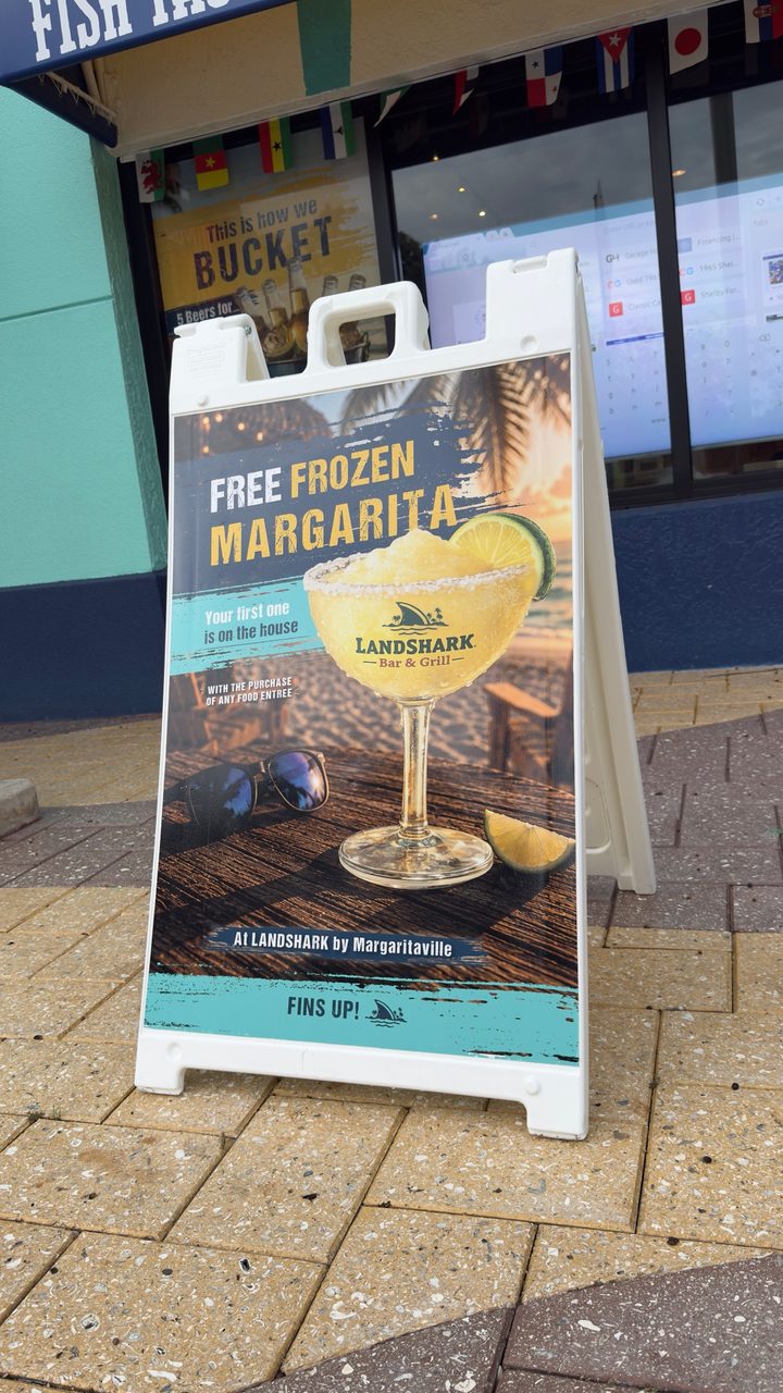 An A-frame sign set up at the door of a restaurant