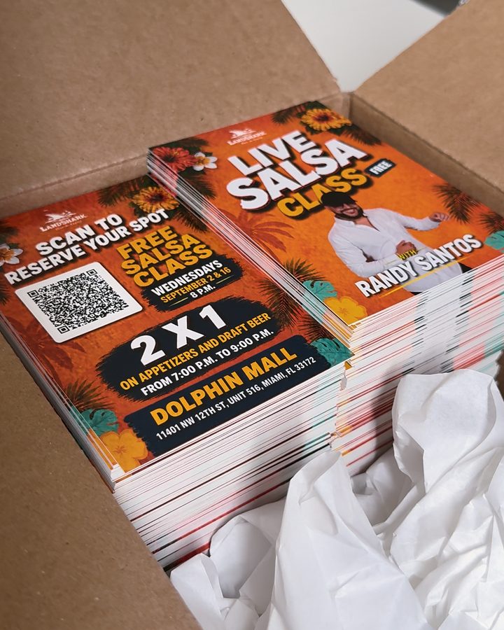 An open box of freshly printed flyers