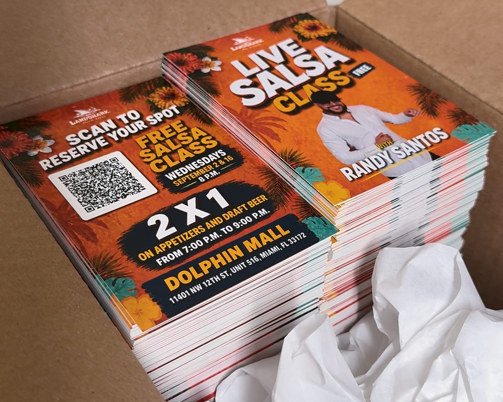 An open box of freshly printed flyers